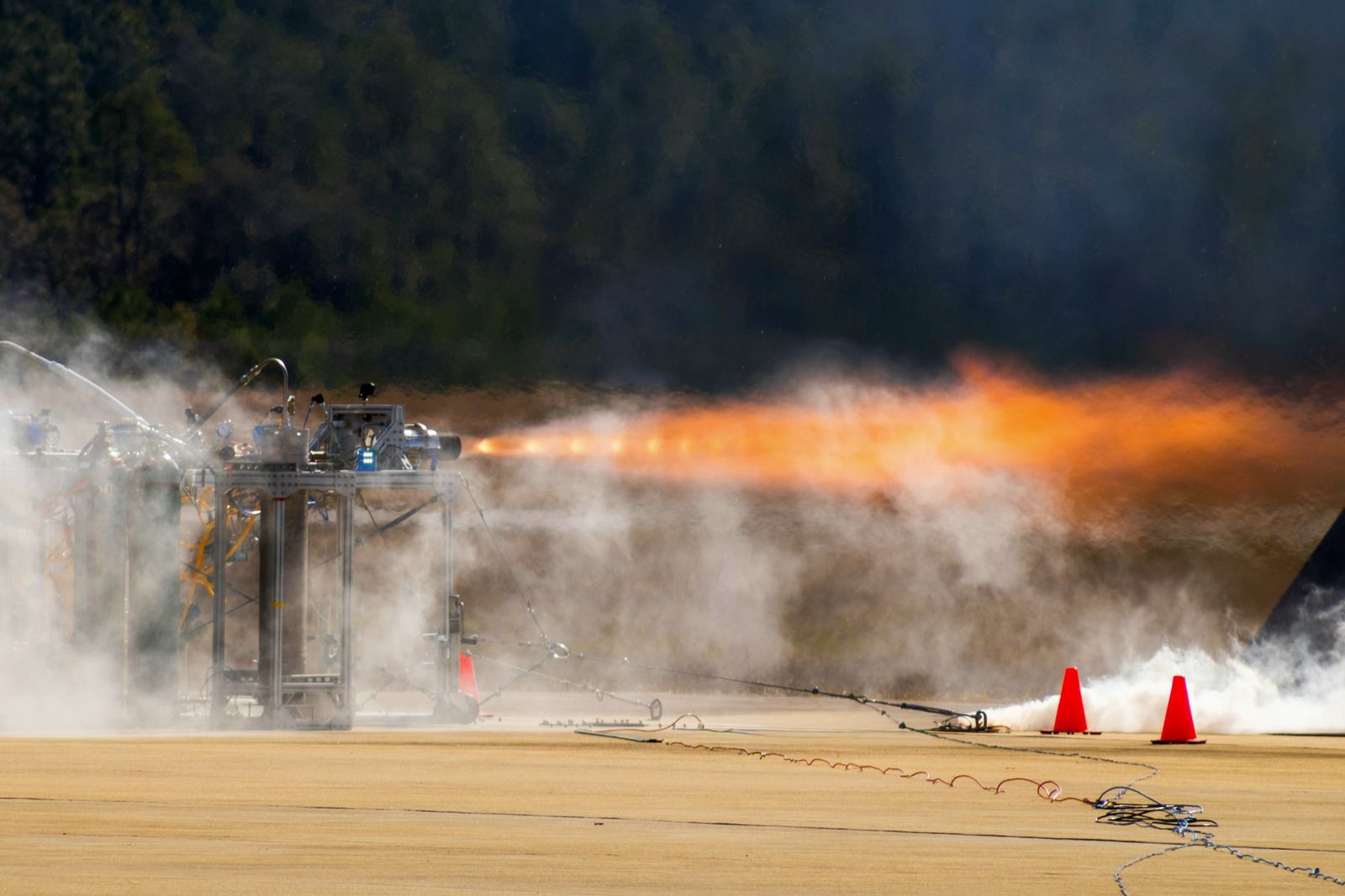 A student-built rocket engine hotfire on a desert test stand