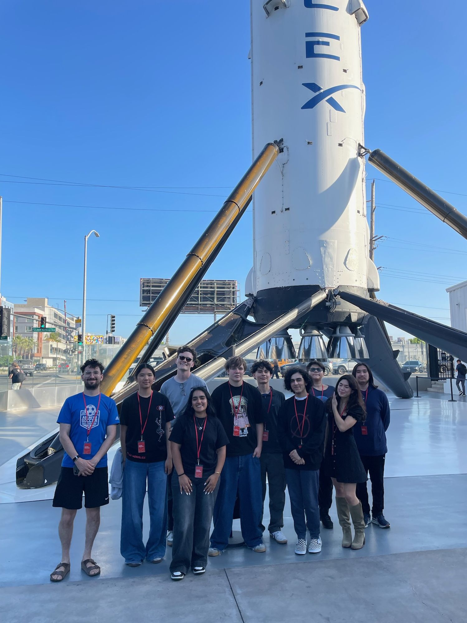 Students in front of a flown SpaceX Falcon 9 booster