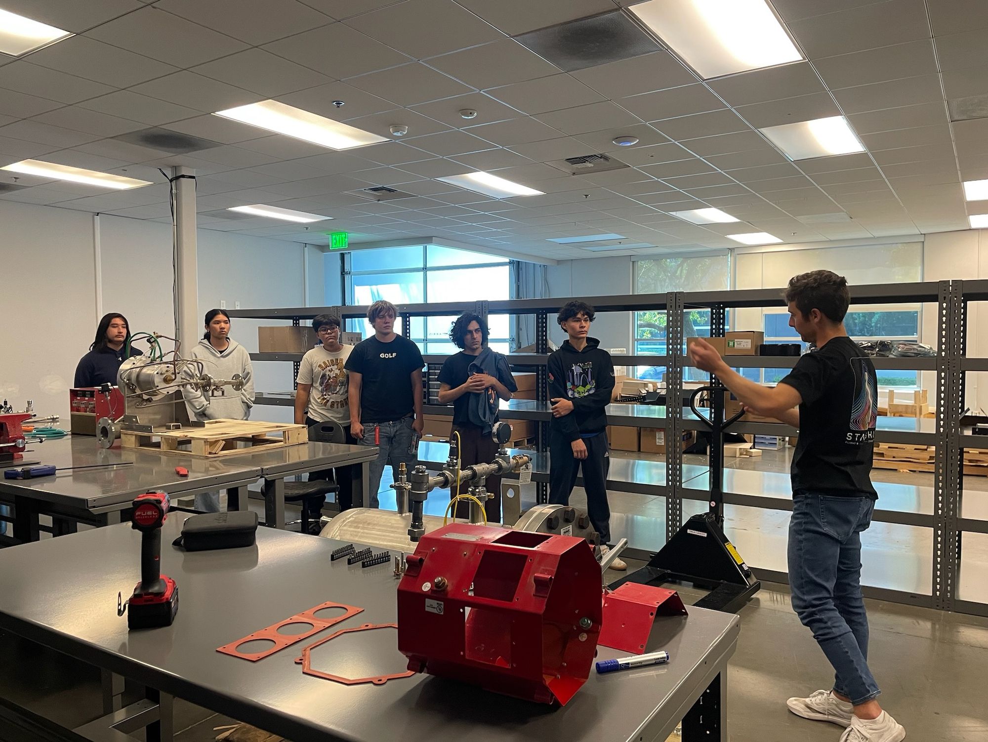 A mentor working with students in the lab